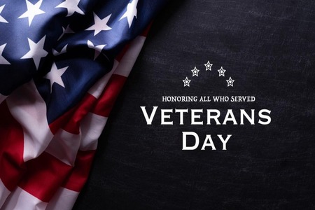 American Flag on dark background. “Honoring all who served: Veterans Day.”